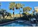 Shared pool and spa with patio furniture and lake view at 8035 Surf St, Kissimmee, FL 34747