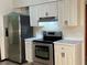 Clean kitchen with stainless steel appliances and white cabinets at 8568 Park Highland Dr, Orlando, FL 32818