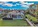 Backyard oasis featuring a large pool, screened lanai, and private dock at 9301 Tibet Pointe Cir, Windermere, FL 34786