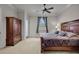 Spacious bedroom with wooden furniture and a ceiling fan at 9301 Tibet Pointe Cir, Windermere, FL 34786