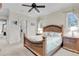 Spacious bedroom featuring a wooden bedframe, ceiling fan, and carpeted floors at 9301 Tibet Pointe Cir, Windermere, FL 34786