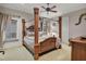 Spacious bedroom with large four-poster bed and ceiling fan at 9301 Tibet Pointe Cir, Windermere, FL 34786