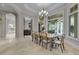 Bright dining room with large windows and seating for eight at 9301 Tibet Pointe Cir, Windermere, FL 34786