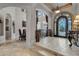 Spacious entryway with high ceilings, elegant staircase, and ornate iron door at 9301 Tibet Pointe Cir, Windermere, FL 34786