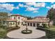 Luxury home with circular driveway, fountain, and three-car garage at 9301 Tibet Pointe Cir, Windermere, FL 34786
