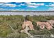 Lakefront luxury home with tile roof, circular driveway, and lush landscaping at 9301 Tibet Pointe Cir, Windermere, FL 34786