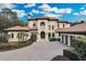 Two-story house featuring a grand entrance and brick paver driveway at 9301 Tibet Pointe Cir, Windermere, FL 34786