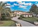Impressive two-story home with a circular driveway and manicured landscaping at 9301 Tibet Pointe Cir, Windermere, FL 34786