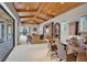 Game room with wood-beamed ceiling, wet bar, and sliding doors to the patio and pool at 9301 Tibet Pointe Cir, Windermere, FL 34786