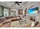 Relaxing living room features sectional sofa and large TV at 9301 Tibet Pointe Cir, Windermere, FL 34786