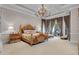 Spacious main bedroom with a large bed and access to a private balcony at 9301 Tibet Pointe Cir, Windermere, FL 34786