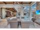 Covered patio with dining table and chairs, overlooking the pool and adjacent game room at 9301 Tibet Pointe Cir, Windermere, FL 34786