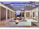 Luxury pool area with fire pit, screened enclosure, and water views at 9301 Tibet Pointe Cir, Windermere, FL 34786