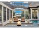 Screened-in pool area with fire pit, seating, and lake views at 9301 Tibet Pointe Cir, Windermere, FL 34786