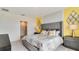 Bedroom with gray upholstered bed and view of bathroom at 1296 Hanoverian Dr, Lake Alfred, FL 33850