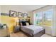 Cozy bedroom with gray walls, large window, and a full-size bed at 1300 Hanoverian Dr, Lake Alfred, FL 33850
