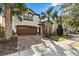 Two-story house with brown garage door and brick driveway, palm trees at 1857 Gobi Dr, Kissimmee, FL 34747