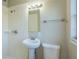 Clean bathroom with pedestal sink and shower at 1921 Rockwell Rd, Orlando, FL 32808