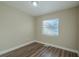 Spacious bedroom with wood-look floors and a window at 1921 Rockwell Rd, Orlando, FL 32808