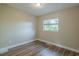 Spacious bedroom with wood-look floors and a window at 1921 Rockwell Rd, Orlando, FL 32808