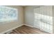 Bedroom with wood-look floors and window with blinds at 1921 Rockwell Rd, Orlando, FL 32808