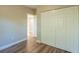 Bedroom with wood-look floors and large closet at 1921 Rockwell Rd, Orlando, FL 32808