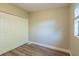 Bedroom with wood-look floors and large closet at 1921 Rockwell Rd, Orlando, FL 32808
