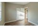Bedroom with wood-look floors, window, and double doors at 1921 Rockwell Rd, Orlando, FL 32808