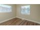 Bright bedroom featuring wood-look floors and multiple windows at 1921 Rockwell Rd, Orlando, FL 32808