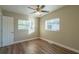 Bedroom with ceiling fan, wood floors, and ample natural light at 1921 Rockwell Rd, Orlando, FL 32808