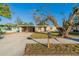 Tan single story home with carport and mature landscaping at 1921 Rockwell Rd, Orlando, FL 32808