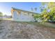 Back of house with a large yard and mature trees at 1921 Rockwell Rd, Orlando, FL 32808