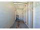 Unfinished laundry room with water heater and shelving at 1921 Rockwell Rd, Orlando, FL 32808