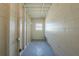 Laundry area with overhead shelving and bright lighting at 1921 Rockwell Rd, Orlando, FL 32808