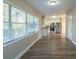 Open living room and kitchen with wood-look floors at 1921 Rockwell Rd, Orlando, FL 32808