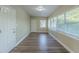 Bright sunroom with wood-look floors and large windows at 1921 Rockwell Rd, Orlando, FL 32808