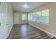 Bright sunroom with wood-look floors and large windows at 1921 Rockwell Rd, Orlando, FL 32808