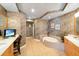 Large bathroom with a jacuzzi tub, double vanity, and tiled floors at 1925 S Atlantic Ave # 502, Daytona Beach, FL 32118
