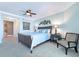 Spacious bedroom with a large bed, nightstand, and ceiling fan at 1925 S Atlantic Ave # 502, Daytona Beach, FL 32118