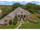Stunning aerial view of a luxury home with a well-manicured lawn and landscaping at 25510 High Hampton Cir, Sorrento, FL 32776