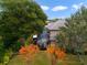 Backyard with screened-in pool, landscaping, trees, and a glimpse of nearby homes at 25510 High Hampton Cir, Sorrento, FL 32776