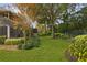Private backyard oasis with lush landscaping, mature trees, and a fenced perimeter at 25510 High Hampton Cir, Sorrento, FL 32776