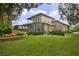 Backyard with screened patio, lush lawn, and landscaping at 25510 High Hampton Cir, Sorrento, FL 32776