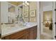 Elegant bathroom featuring double vanity, granite countertops, and framed artwork at 25510 High Hampton Cir, Sorrento, FL 32776