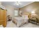 Bedroom with a bed, rocking chair, nightstands, and ceiling fan at 25510 High Hampton Cir, Sorrento, FL 32776
