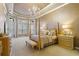 Spacious bedroom with four-poster bed, chandelier, and plush carpet at 25510 High Hampton Cir, Sorrento, FL 32776