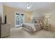 Bedroom with a comfortable bed, balcony access, and neutral decor at 25510 High Hampton Cir, Sorrento, FL 32776