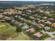 Aerial perspective of a golf course community with homes, trees, and open areas at 25510 High Hampton Cir, Sorrento, FL 32776