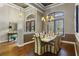 Formal dining room with chandelier, decorative half-wall, and hardwood floors at 25510 High Hampton Cir, Sorrento, FL 32776