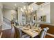 Dining room with chandelier, hardwood floors, and view of the living area at 25510 High Hampton Cir, Sorrento, FL 32776